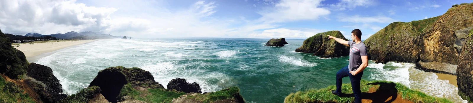 Vitor Lindo looking out over a broad rocky coastline